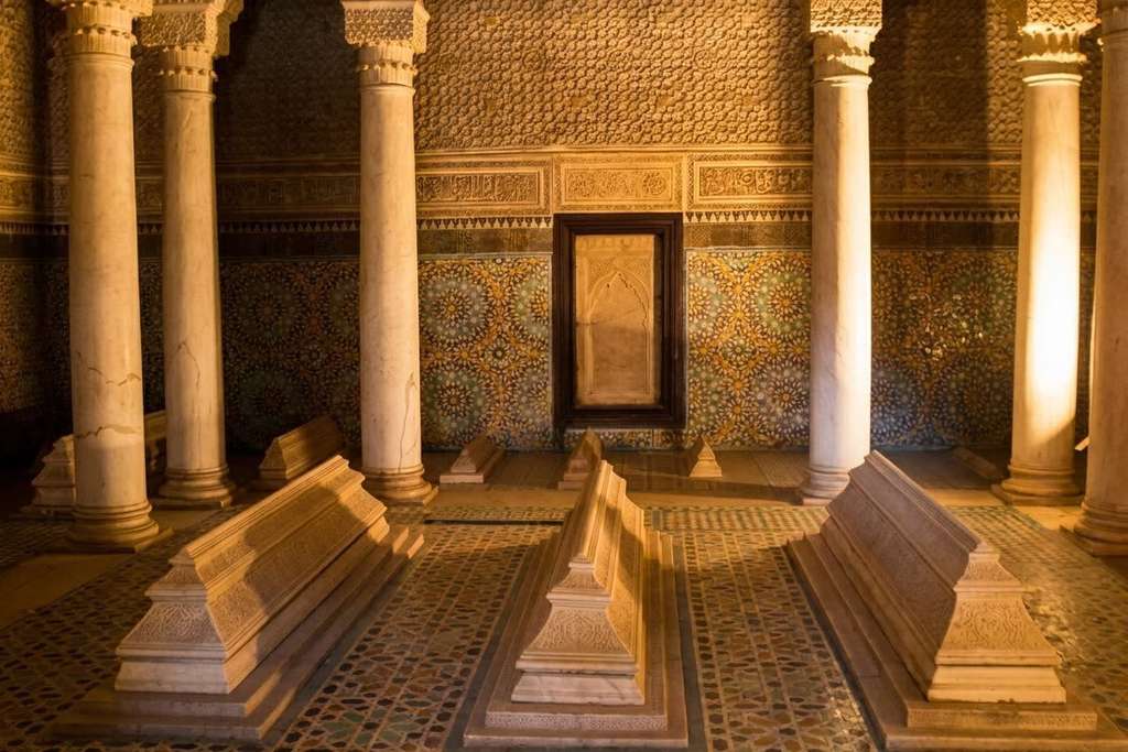 Warm-lit funerary chamber with marble tombs at the Saadian Tombs